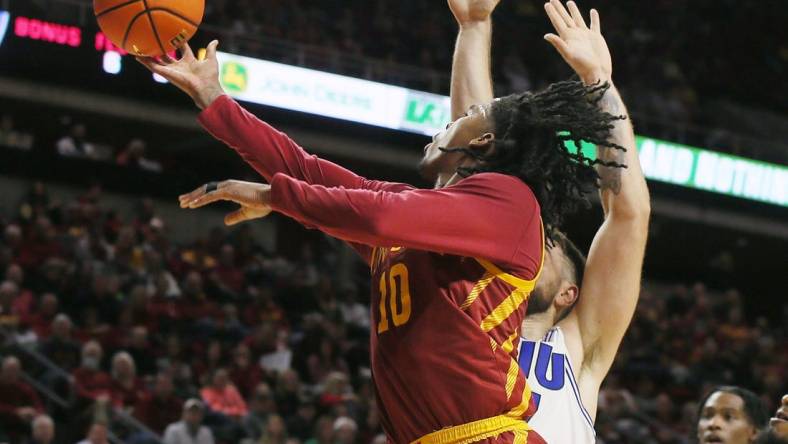 Iowa State Cyclones guard Keshon Gilbert (10) lays up the ball around Eastern Illinois Panthers forward Lazar Grbovic (17)during the first half of a NCAA college basketball at Hilton Coliseum on Thursday, Dec. 21, 2023, in Ames, Iowa.