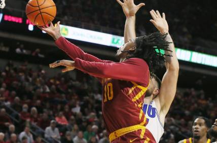 Iowa State Cyclones guard Keshon Gilbert (10) lays up the ball around Eastern Illinois Panthers forward Lazar Grbovic (17)during the first half of a NCAA college basketball at Hilton Coliseum on Thursday, Dec. 21, 2023, in Ames, Iowa.