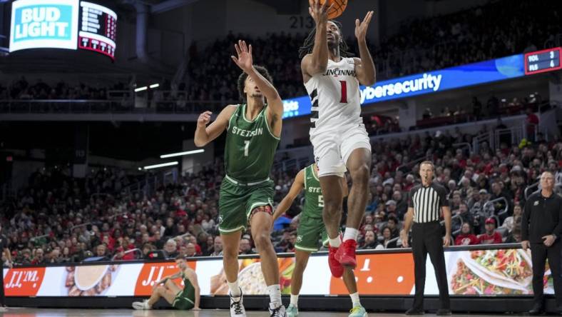 Dec 22, 2023; Cincinnati, Ohio, USA;  Cincinnati Bearcats forward Day Day Thomas (1) drives to the basket against Stetson Hatters guard Tristan Gross (1) in the first half at Fifth Third Arena. Mandatory Credit: Aaron Doster-USA TODAY Sports