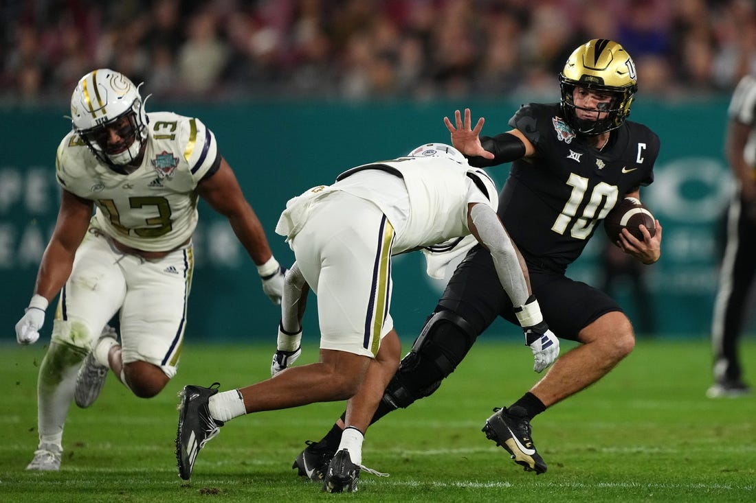 Dec 22, 2023; Tampa, FL, USA; UCF Knights quarterback John Rhys Plumlee (10) runs the ball around Georgia Tech Yellow Jackets defensive back Clayton Powell-Lee (5) during the first half of the Gasparilla Bowl at Raymond James Stadium. Mandatory Credit: Jasen Vinlove-USA TODAY Sports