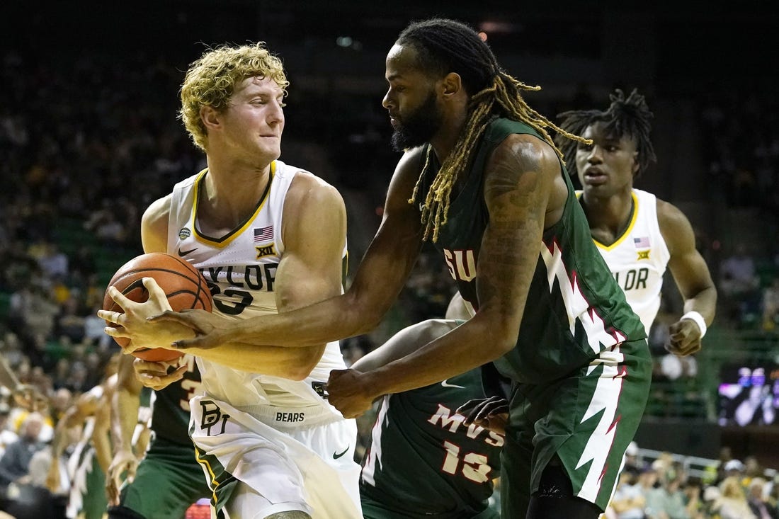 Dec 22, 2023; Waco, Texas, USA; Baylor Bears forward Caleb Lohner (33) grabs the ball from Mississippi Valley State Delta Devils guard Arecko Gipson (23) at Ferrell Center. Mandatory Credit: Raymond Carlin III-USA TODAY Sports