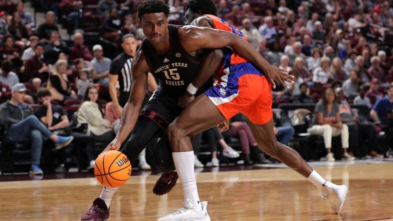 Dec 22, 2023; College Station, Texas, USA; Texas A&M Aggies forward Henry Coleman III (15) handles the ball inside against Houston Christian Huskies forward Chigozie Achara (20) during the first half at Reed Arena. Mandatory Credit: Erik Williams-USA TODAY Sports