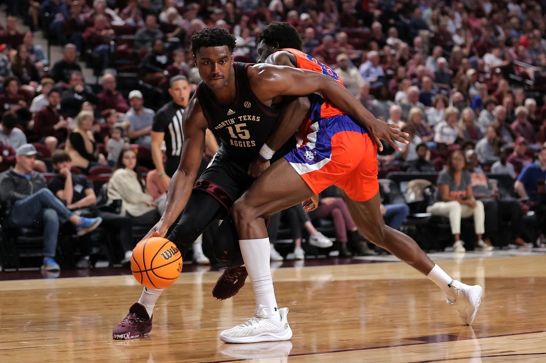Dec 22, 2023; College Station, Texas, USA; Texas A&M Aggies forward Henry Coleman III (15) handles the ball inside against Houston Christian Huskies forward Chigozie Achara (20) during the first half at Reed Arena. Mandatory Credit: Erik Williams-USA TODAY Sports