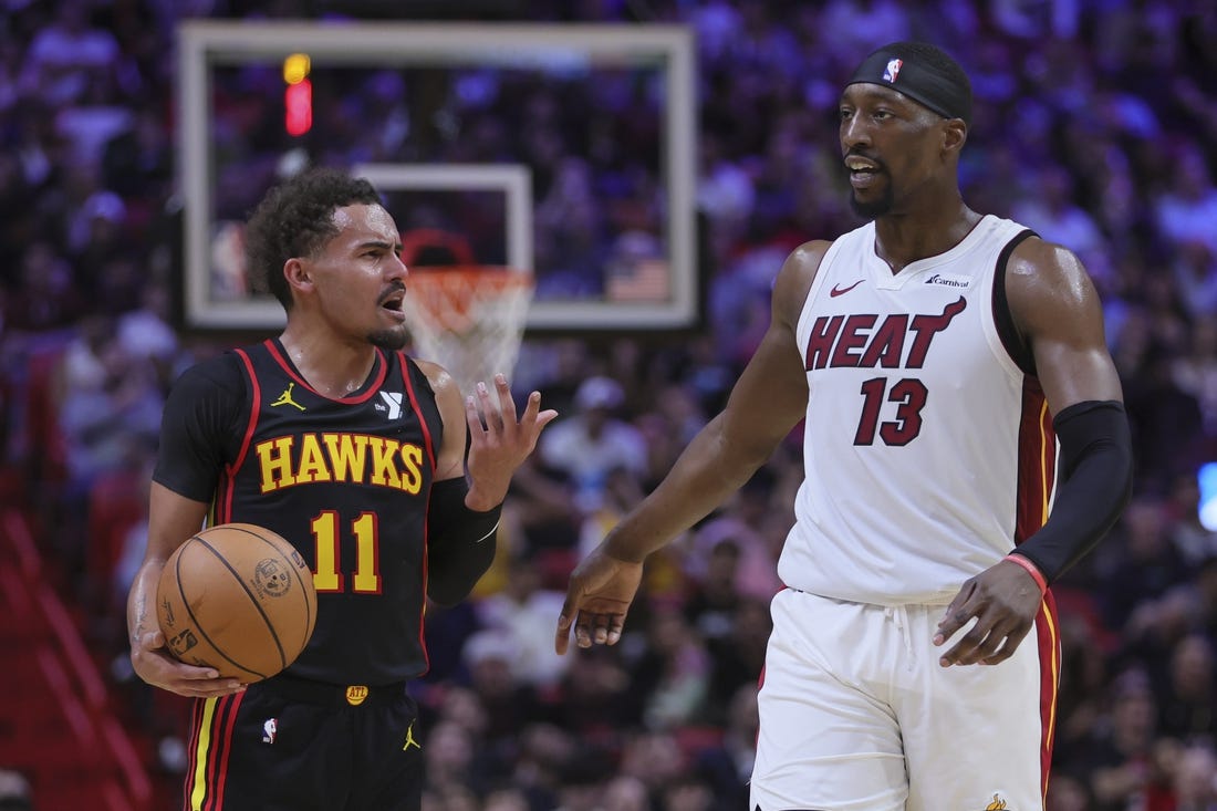 Dec 22, 2023; Miami, Florida, USA; Atlanta Hawks guard Trae Young (11) and Miami Heat center Bam Adebayo (13) talk during the second quarter at Kaseya Center. Mandatory Credit: Sam Navarro-USA TODAY Sports