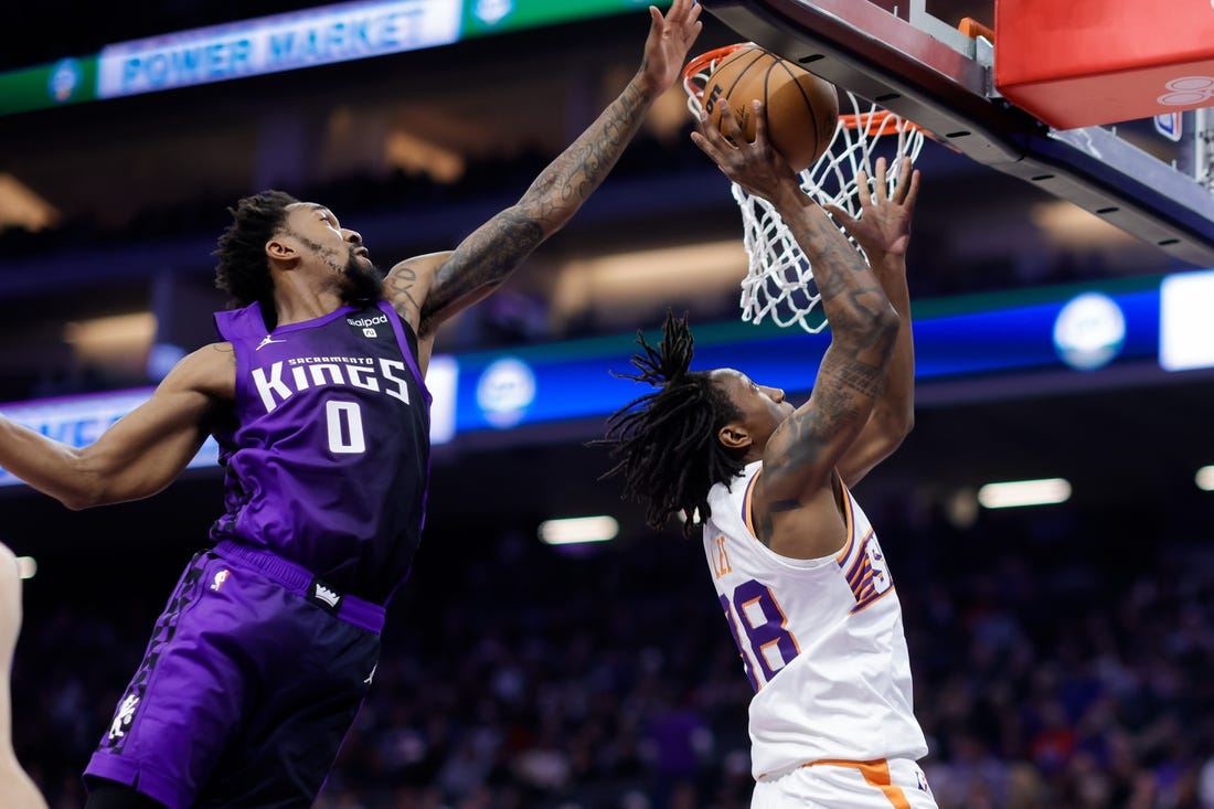 Dec 22, 2023; Sacramento, California, USA; Sacramento Kings guard Malik Monk (0) blocks a shot by Phoenix Suns guard Saben Lee (38) during the second quarter at Golden 1 Center. Mandatory Credit: Sergio Estrada-USA TODAY Sports