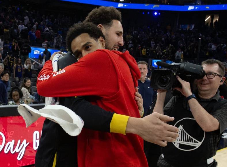 Dec 22, 2023; San Francisco, California, USA; Golden State Warriors guard Klay Thompson (left) embraces former teammate Washington Wizards guard Jordan Poole following their game at Chase Center. Mandatory Credit: D. Ross Cameron-USA TODAY Sports