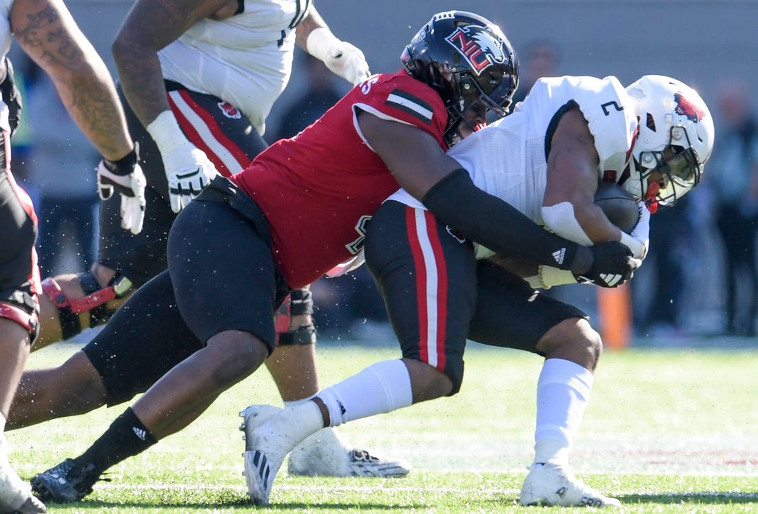 Arkansas State Red Wolves running back Ja'Quez Cross (2) is stopped by Northern Illinois Huskies defensive end Raishein Thomas (4) in first half action in the Camellia Bowl at Cramton Bowl in Montgomery, Ala., on Saturday December 23, 2023.
