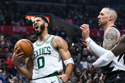 Dec 23, 2023; Los Angeles, California, USA; Boston Celtics forward Jayson Tatum (0) celebrates after scoring against Los Angeles Clippers center Daniel Theis (10) during the first quarter at Crypto.com Arena. Mandatory Credit: Jonathan Hui-USA TODAY Sports