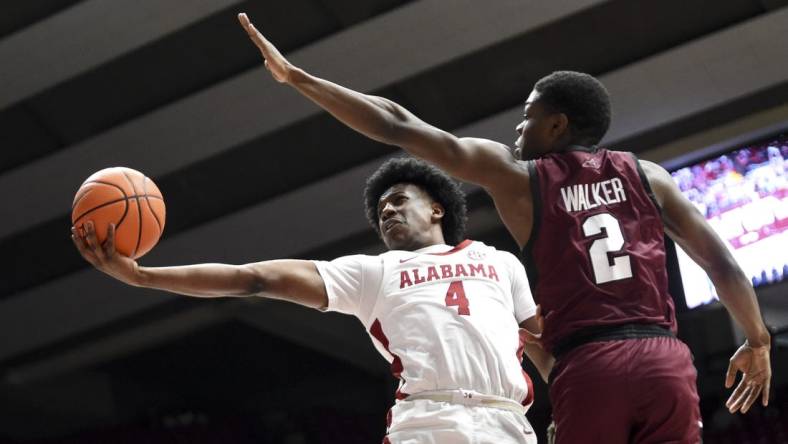 Dec 23, 2023; Tuscaloosa, Alabama, USA;  Alabama guard Davin Cosby Jr. (4) attempts a shot inside with Eastern Kentucky guard Leland Walker (2) defending at Coleman Coliseum. Mandatory Credit: Gary Cosby Jr.-USA TODAY Sports