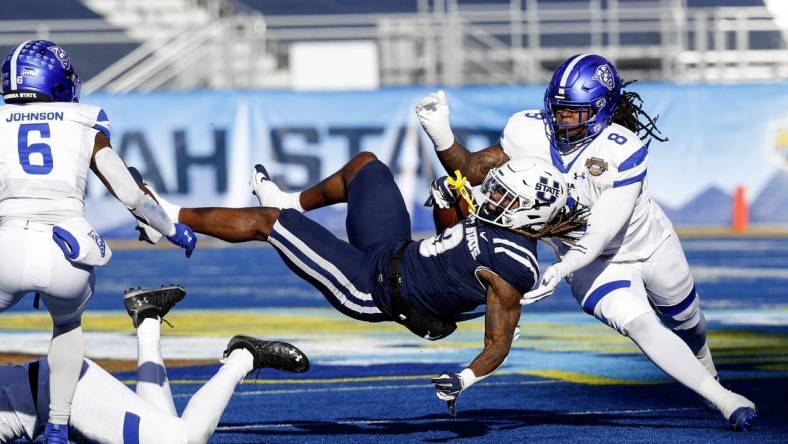 Dec 23, 2023; Boise, ID, USA; Utah State Aggies running back Rahsul Faison (3) is tackled during the first half against the Georgia State Panthers at Albertsons Stadium. Mandatory Credit: Brian Losness-USA TODAY Sports