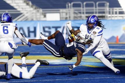 Dec 23, 2023; Boise, ID, USA; Utah State Aggies running back Rahsul Faison (3) is tackled during the first half against the Georgia State Panthers at Albertsons Stadium. Mandatory Credit: Brian Losness-USA TODAY Sports