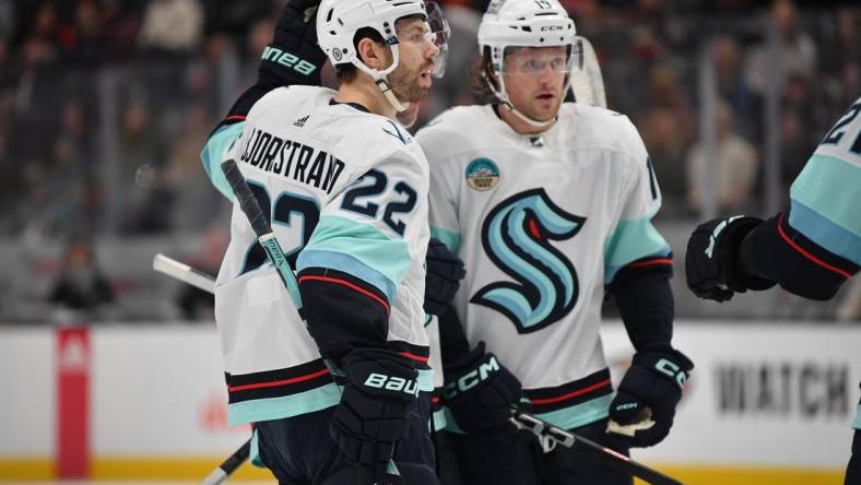 Dec 23, 2023; Anaheim, California, USA; Seattle Kraken right wing Oliver Bjorkstrand (22) celebrates his goal scored against the Anaheim Ducks with left wing Jared McCann (19) during the first period at Honda Center. Mandatory Credit: Gary A. Vasquez-USA TODAY Sports