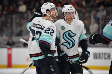 Dec 23, 2023; Anaheim, California, USA; Seattle Kraken right wing Oliver Bjorkstrand (22) celebrates his goal scored against the Anaheim Ducks with left wing Jared McCann (19) during the first period at Honda Center. Mandatory Credit: Gary A. Vasquez-USA TODAY Sports