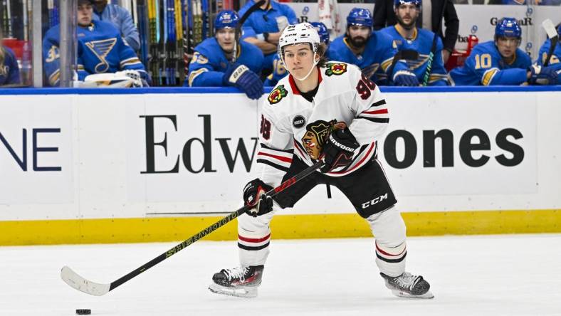 Dec 23, 2023; St. Louis, Missouri, USA;  Chicago Blackhawks center Connor Bedard (98) controls the puck against the St. Louis Blues during the first period at Enterprise Center. Mandatory Credit: Jeff Curry-USA TODAY Sports