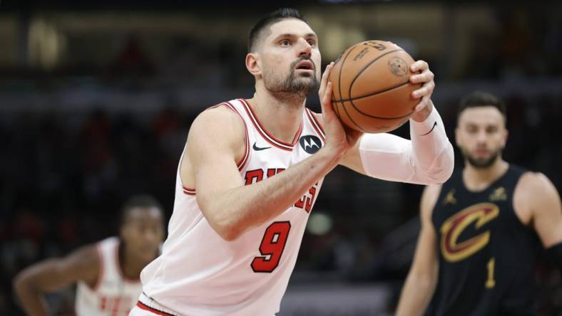 Dec 23, 2023; Chicago, Illinois, USA; Chicago Bulls center Nikola Vucevic (9) shoots a free throw against the Cleveland Cavaliers during the first half at United Center. Mandatory Credit: Kamil Krzaczynski-USA TODAY Sports