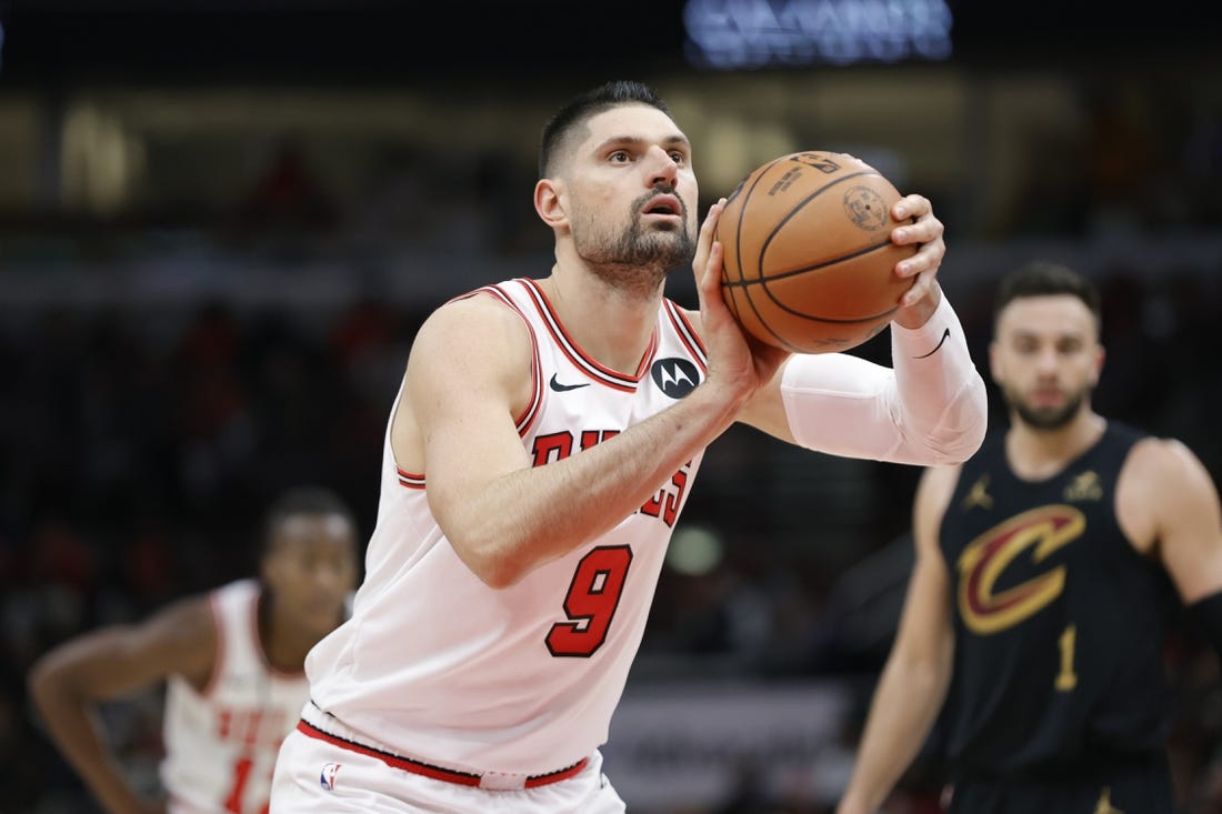 Dec 23, 2023; Chicago, Illinois, USA; Chicago Bulls center Nikola Vucevic (9) shoots a free throw against the Cleveland Cavaliers during the first half at United Center. Mandatory Credit: Kamil Krzaczynski-USA TODAY Sports