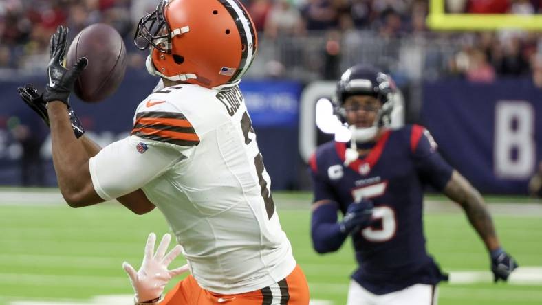 Dec 24, 2023; Houston, Texas, USA; Cleveland Browns wide receiver Amari Cooper (2) catches a touchdown pass with Houston Texans safety Jalen Pitre (5) chasing in the second quarter at NRG Stadium. Mandatory Credit: Thomas Shea-USA TODAY Sports