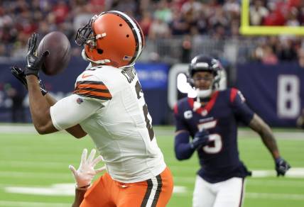 Dec 24, 2023; Houston, Texas, USA; Cleveland Browns wide receiver Amari Cooper (2) catches a touchdown pass with Houston Texans safety Jalen Pitre (5) chasing in the second quarter at NRG Stadium. Mandatory Credit: Thomas Shea-USA TODAY Sports