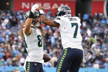 Dec 24, 2023; Nashville, Tennessee, USA; Seattle Seahawks tight end Colby Parkinson (84) celebrates with quarterback Geno Smith (7) after scoring the game-winning touchdown during the second half against the Tennessee Titans at Nissan Stadium. Mandatory Credit: Christopher Hanewinckel-USA TODAY Sports