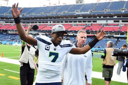 Dec 24, 2023; Nashville, Tennessee, USA; Seattle Seahawks quarterback Geno Smith (7) celebrates as he leaves the field after a win against the Tennessee Titans at Nissan Stadium. Mandatory Credit: Christopher Hanewinckel-USA TODAY Sports