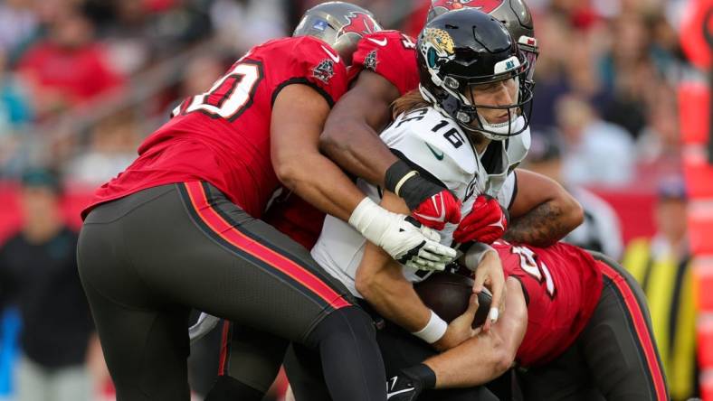 Dec 24, 2023; Tampa, Florida, USA;  Jacksonville Jaguars quarterback Trevor Lawrence (16) is sacked by Tampa Bay Buccaneers linebacker Lavonte David (54) in the second quarter at Raymond James Stadium. Mandatory Credit: Nathan Ray Seebeck-USA TODAY Sports