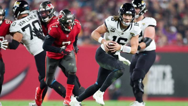 Dec 24, 2023; Tampa, Florida, USA;  Jacksonville Jaguars quarterback Trevor Lawrence (16) runs with the ball against the Tampa Bay Buccaneers in the third quarter at Raymond James Stadium. Mandatory Credit: Nathan Ray Seebeck-USA TODAY Sports