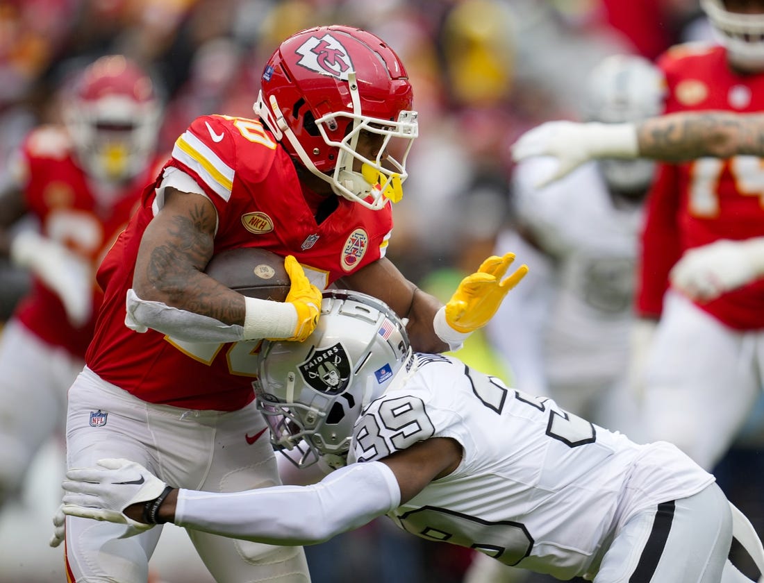 Dec 25, 2023; Kansas City, Missouri, USA; Kansas City Chiefs running back Isiah Pacheco (10) runs the ball against Las Vegas Raiders cornerback Nate Hobbs (39) during the first half at GEHA Field at Arrowhead Stadium. Mandatory Credit: Jay Biggerstaff-USA TODAY Sports