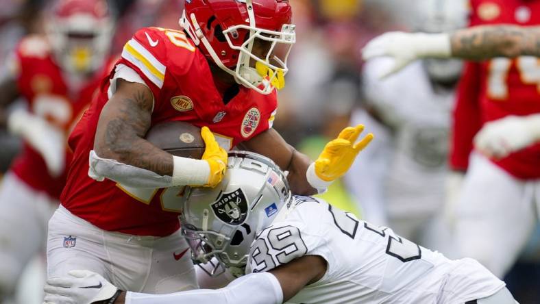 Dec 25, 2023; Kansas City, Missouri, USA; Kansas City Chiefs running back Isiah Pacheco (10) runs the ball against Las Vegas Raiders cornerback Nate Hobbs (39) during the first half at GEHA Field at Arrowhead Stadium. Mandatory Credit: Jay Biggerstaff-USA TODAY Sports