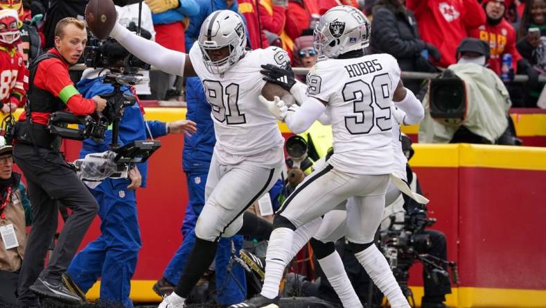 Dec 25, 2023; Kansas City, Missouri, USA; Las Vegas Raiders defensive tackle Bilal Nichols (91) scores against the Kansas City Chiefs after picking up a fumble during the first half at GEHA Field at Arrowhead Stadium. Mandatory Credit: Denny Medley-USA TODAY Sports