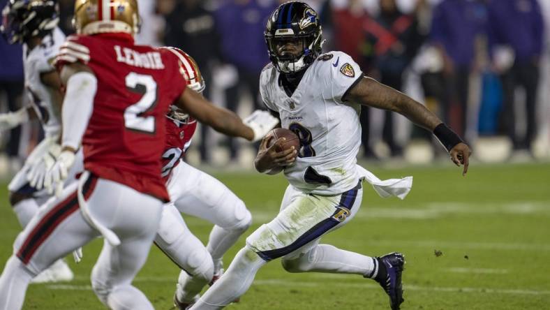 Dec 25, 2023; Santa Clara, California, USA; Baltimore Ravens quarterback Lamar Jackson (8) scrambles with the football against San Francisco 49ers safety Ji'Ayir Brown (27) during the second quarter at Levi's Stadium. Mandatory Credit: Neville E. Guard-USA TODAY Sports