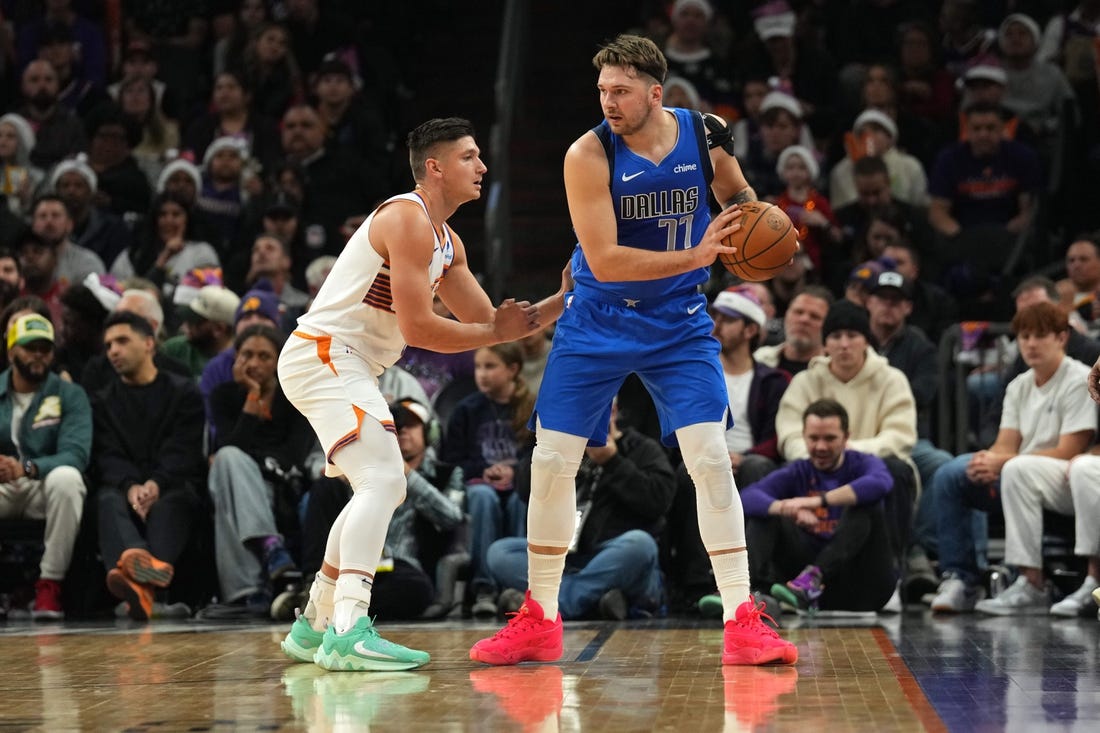 Dec 25, 2023; Phoenix, Arizona, USA; Phoenix Suns guard Grayson Allen (8) guards Dallas Mavericks guard Luka Doncic (77) during the first half at Footprint Center. Mandatory Credit: Joe Camporeale-USA TODAY Sports