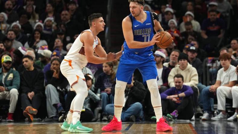 Dec 25, 2023; Phoenix, Arizona, USA; Phoenix Suns guard Grayson Allen (8) guards Dallas Mavericks guard Luka Doncic (77) during the first half at Footprint Center. Mandatory Credit: Joe Camporeale-USA TODAY Sports