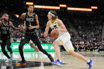 Dec 26, 2023; San Antonio, Texas, USA; Utah Jazz forward Kelly Olynyk (41) drives to the basket against San Antonio Spurs center Victor Wembanyama (1) in the first half at the Frost Bank Center. Mandatory Credit: Daniel Dunn-USA TODAY Sports