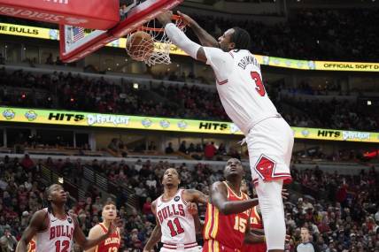 Dec 26, 2023; Chicago, Illinois, USA; Chicago Bulls center Andre Drummond (3) dunks the ball over Atlanta Hawks center Clint Capela (15) during the first quarter at United Center. Mandatory Credit: David Banks-USA TODAY Sports