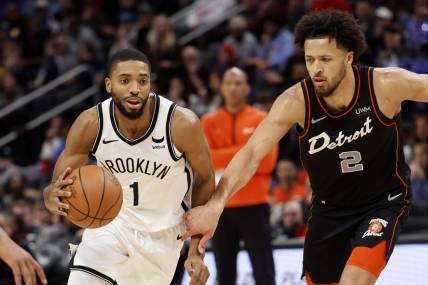Dec 26, 2023; Detroit, Michigan, USA; Brooklyn Nets forward Mikal Bridges (1) dribbles while defended by Detroit Pistons guard Cade Cunningham (2) in the second half at Little Caesars Arena. Mandatory Credit: Rick Osentoski-USA TODAY Sports