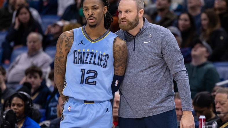 Dec 26, 2023; New Orleans, Louisiana, USA; Memphis Grizzlies head coach Taylor Jenkins talks with guard Ja Morant (12) in the second half against the New Orleans Pelicans at the Smoothie King Center. Mandatory Credit: Stephen Lew-USA TODAY Sports