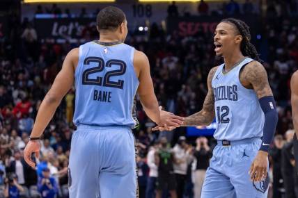 Dec 26, 2023; New Orleans, Louisiana, USA; Memphis Grizzlies guard Ja Morant (12) celebrates going to overtime with guard Desmond Bane (22) against the New Orleans Pelicans during the second half at Smoothie King Center. Mandatory Credit: Stephen Lew-USA TODAY Sports