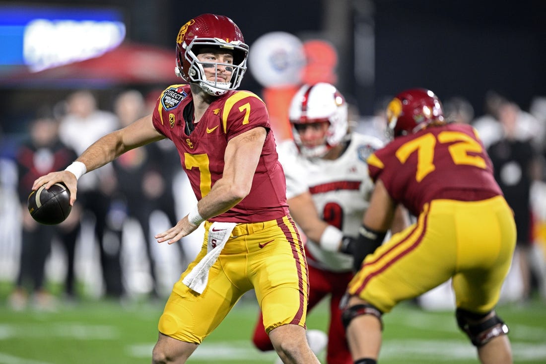 Dec 27, 2023; San Diego, CA, USA; USC Trojans quarterback Miller Moss (7) throws a pass against the Louisville Cardinals during the first half at Petco Park. Mandatory Credit: Orlando Ramirez-USA TODAY Sports