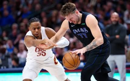 Dec 23, 2023; Dallas, Texas, USA;  Dallas Mavericks guard Luka Doncic (77) looks to controls the ball as Cleveland Cavaliers forward Isaac Okoro (35) defends during the second quarter at American Airlines Center. Mandatory Credit: Kevin Jairaj-USA TODAY Sports