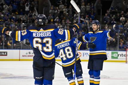 Dec 27, 2023; St. Louis, Missouri, USA;  St. Louis Blues defenseman Marco Scandella (6) celebrates with defenseman Scott Perunovich (48) and left wing Jake Neighbours (63) after scoring against the Dallas Stars during the second period at Enterprise Center. Mandatory Credit: Jeff Curry-USA TODAY Sports