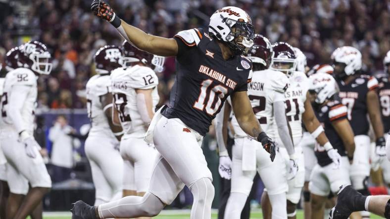 Dec 27, 2023; Houston, TX, USA; Oklahoma State Cowboys wide receiver Rashod Owens (10) celebrates after scoring a touchdown during the first quarter against the Texas A&M Aggies at NRG Stadium. Mandatory Credit: Troy Taormina-USA TODAY Sports