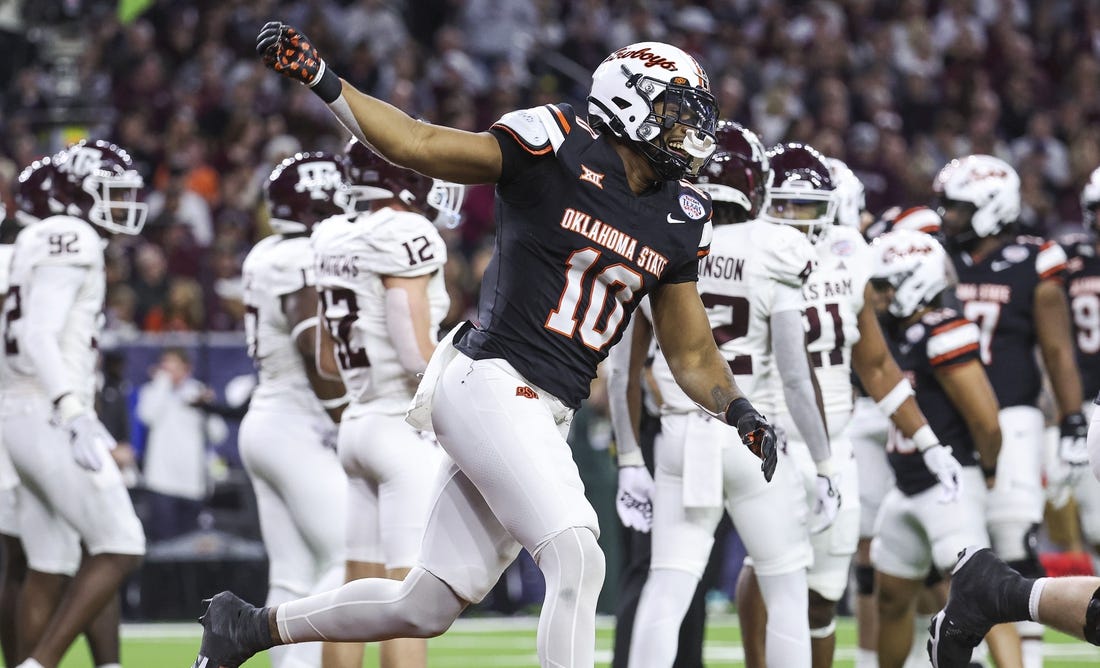 Dec 27, 2023; Houston, TX, USA; Oklahoma State Cowboys wide receiver Rashod Owens (10) celebrates after scoring a touchdown during the first quarter against the Texas A&M Aggies at NRG Stadium. Mandatory Credit: Troy Taormina-USA TODAY Sports