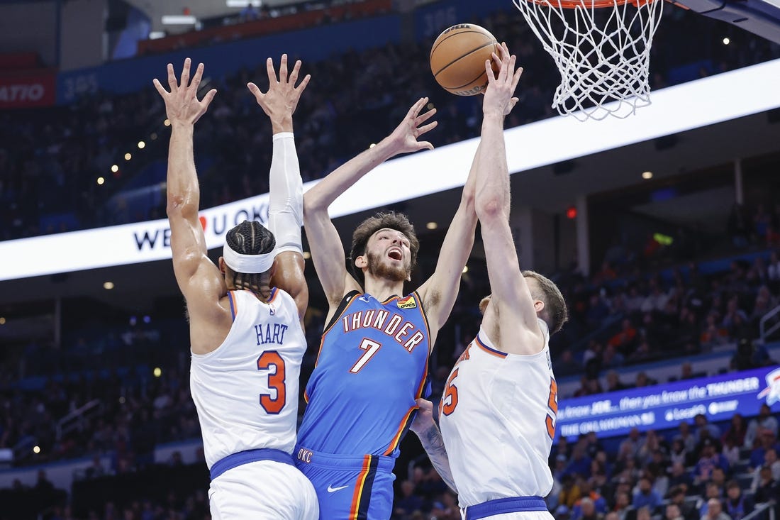 Dec 27, 2023; Oklahoma City, Oklahoma, USA; Oklahoma City Thunder forward Chet Holmgren (7) shoots between New York Knicks guard Josh Hart (3) and center Isaiah Hartenstein (55) during the second half at Paycom Center. Mandatory Credit: Alonzo Adams-USA TODAY Sports