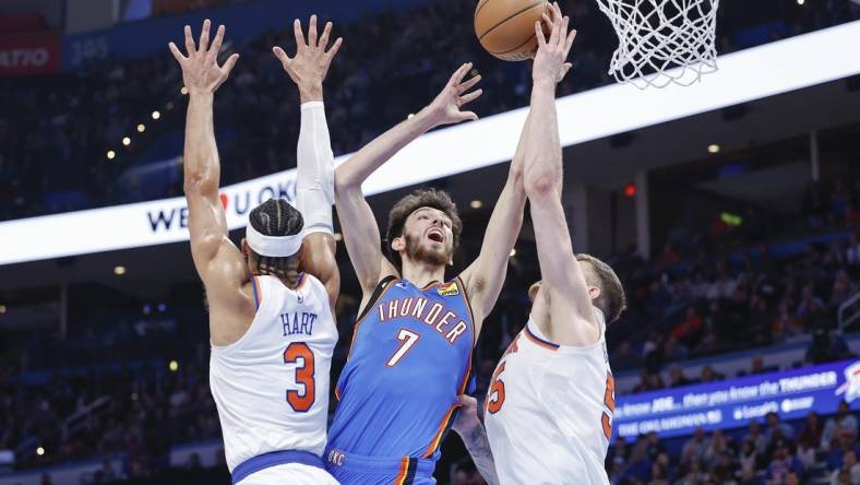 Dec 27, 2023; Oklahoma City, Oklahoma, USA; Oklahoma City Thunder forward Chet Holmgren (7) shoots between New York Knicks guard Josh Hart (3) and center Isaiah Hartenstein (55) during the second half at Paycom Center. Mandatory Credit: Alonzo Adams-USA TODAY Sports