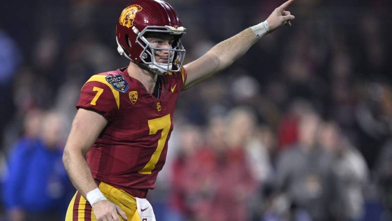 Dec 27, 2023; San Diego, CA, USA; USC Trojans quarterback Miller Moss (7) gestures during a running play against the Louisville Cardinals in the second half at Petco Park. Mandatory Credit: Orlando Ramirez-USA TODAY Sports