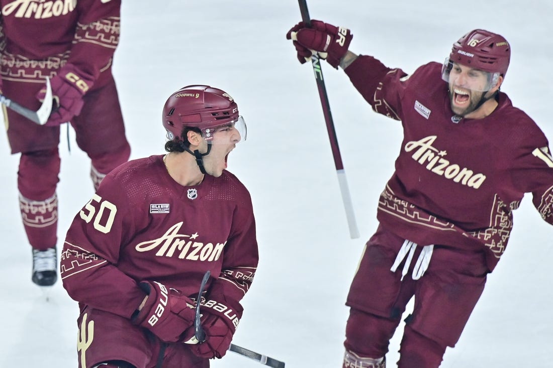 Dec 27, 2023; Tempe, Arizona, USA;  Arizona Coyotes defenseman Sean Durzi (50) celebrates with left wing Jason Zucker (16) after scoring a goal in the third period against the Colorado Avalanche at Mullett Arena. Mandatory Credit: Matt Kartozian-USA TODAY Sports