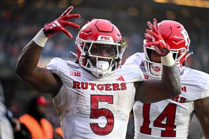 Dec 28, 2023; Bronx, NY, USA; Rutgers Scarlet Knights running back Kyle Monangai (5) celebrates his touchdown against Miami Hurricanes during the second quarter with Rutgers Scarlet Knights wide receiver Isaiah Washington (14) at Yankee Stadium. Mandatory Credit: Mark Smith-USA TODAY Sports