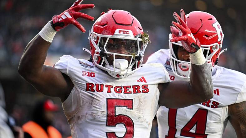 Dec 28, 2023; Bronx, NY, USA; Rutgers Scarlet Knights running back Kyle Monangai (5) celebrates his touchdown against Miami Hurricanes during the second quarter with Rutgers Scarlet Knights wide receiver Isaiah Washington (14) at Yankee Stadium. Mandatory Credit: Mark Smith-USA TODAY Sports