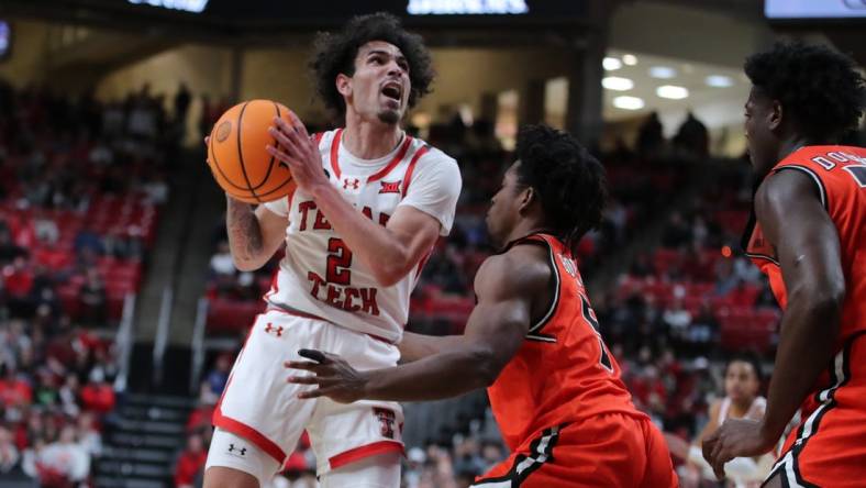 Dec 28, 2023; Lubbock, Texas, USA; Texas Tech Red Raiders guard Pop Isaacs (2) shoots over Sam Houston Bearkats guard Marcus Boykin (5) in the first half at United Supermarkets Arena. Mandatory Credit: Michael C. Johnson-USA TODAY Sports