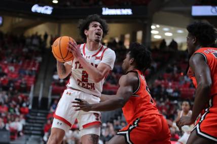 Dec 28, 2023; Lubbock, Texas, USA; Texas Tech Red Raiders guard Pop Isaacs (2) shoots over Sam Houston Bearkats guard Marcus Boykin (5) in the first half at United Supermarkets Arena. Mandatory Credit: Michael C. Johnson-USA TODAY Sports